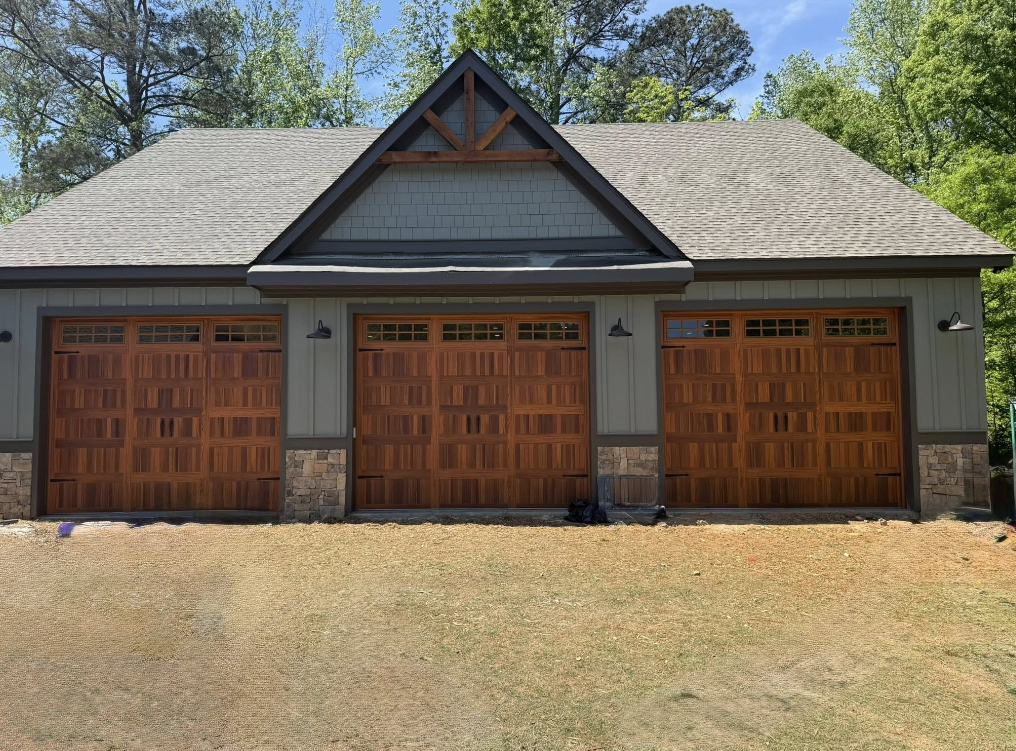 Custom wood-look triple garage door installation in Metro Atlanta