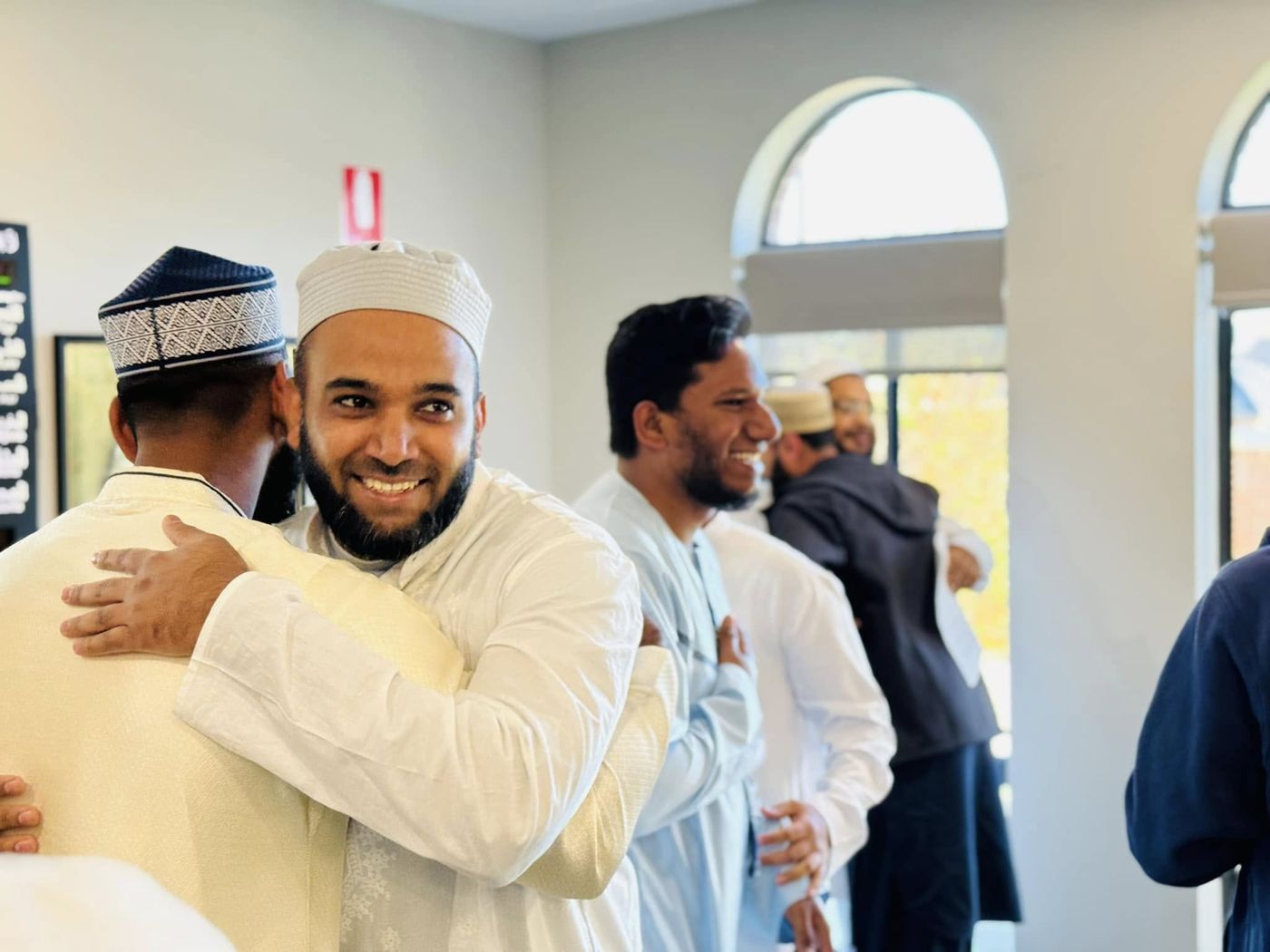 Brothers greeting each other after Eid prayer