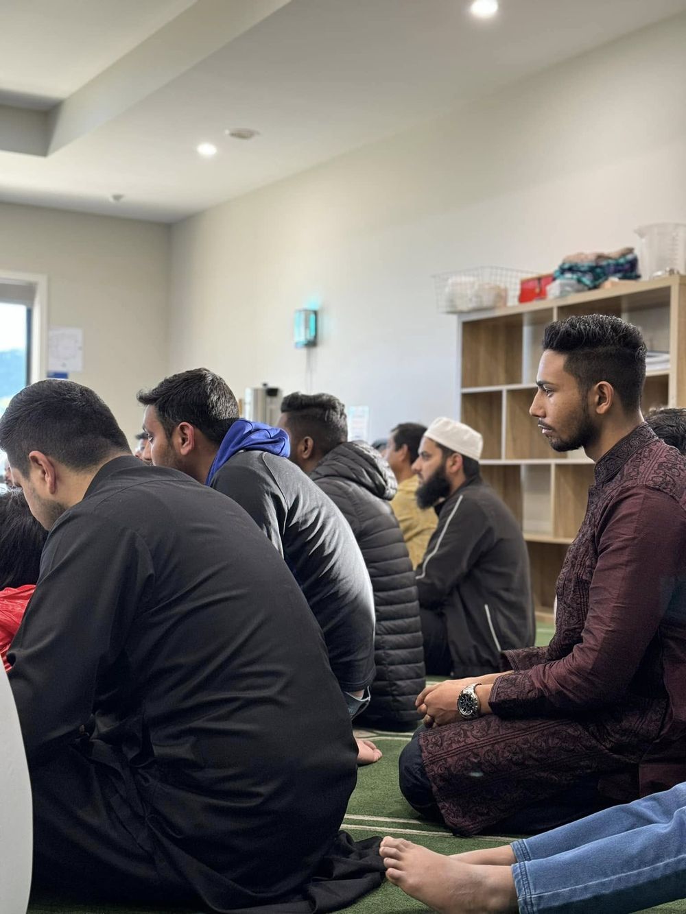 Brothers seated in a circle listening to a lesson