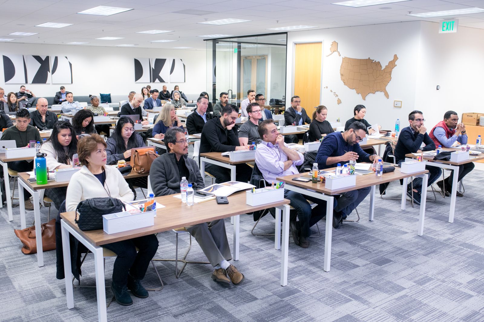 Dental professionals in a classroom listening to Dr. Richard Evangelista