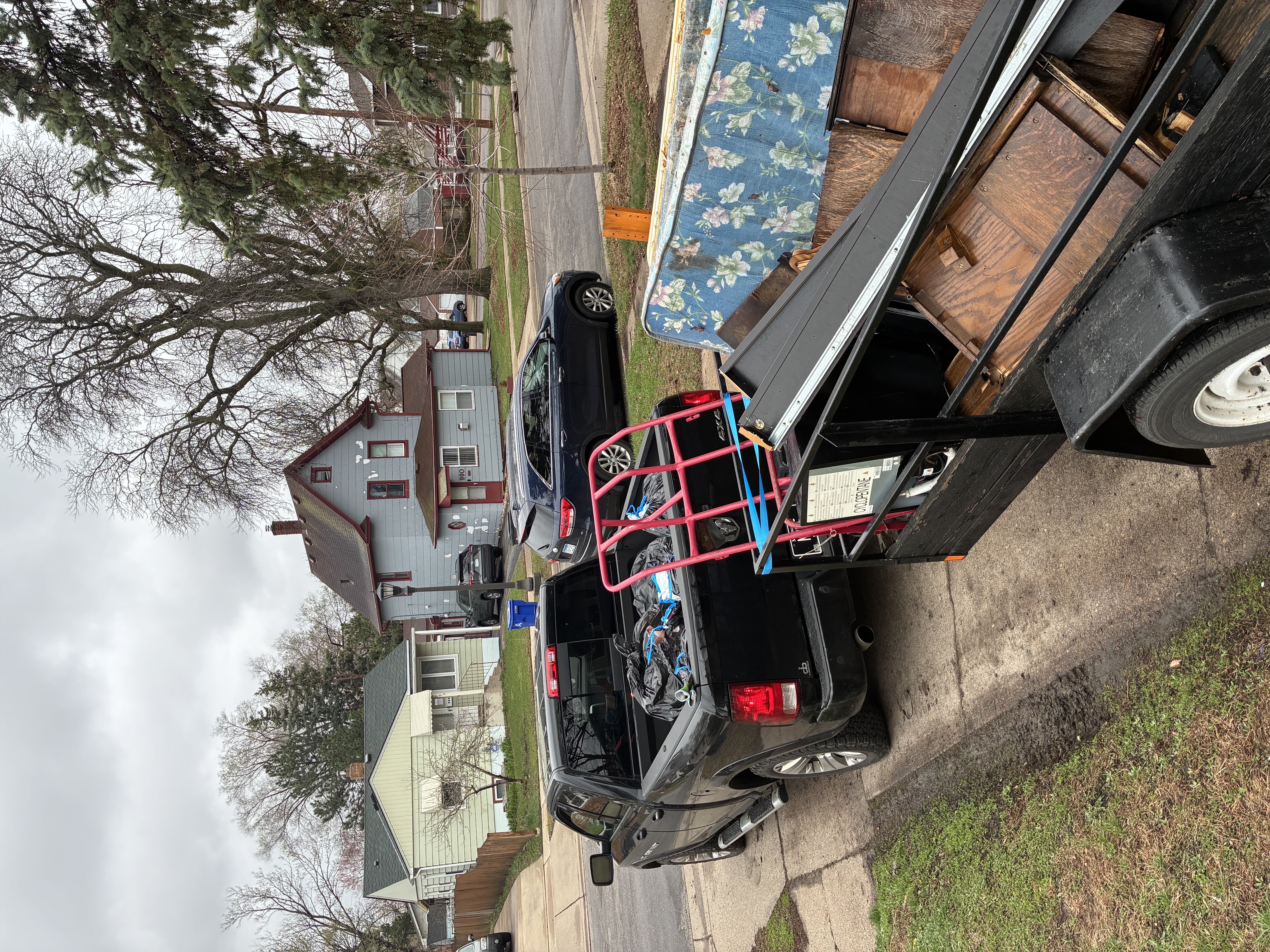 A trailer being loaded during a residential junk removal job