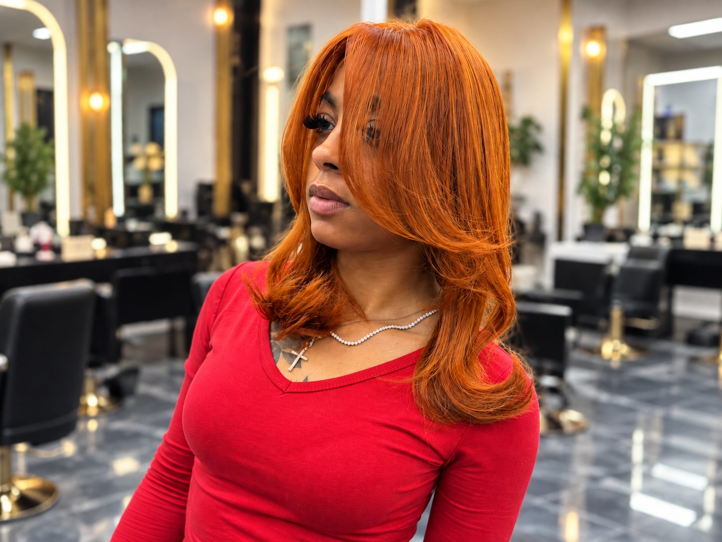 Client wearing a layered copper wig with face-framing curtain bangs
