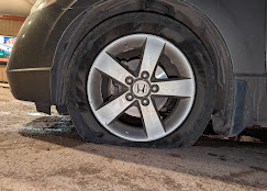 Flat tire on a Honda needing roadside help