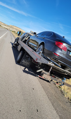 Flatbed tow with sedan loaded