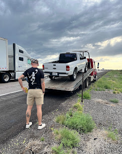 Pickup being towed at sunset on the I-40 corridor