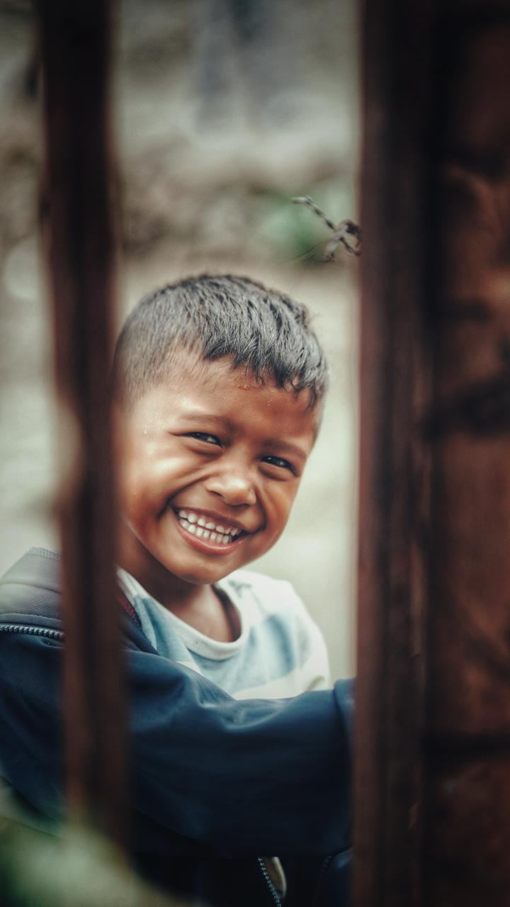 A child looking through slats