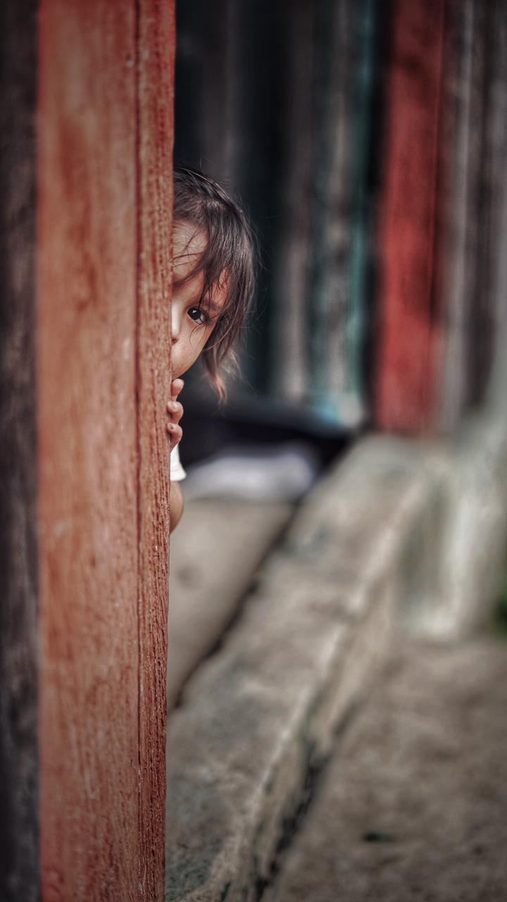 A child against a red wall