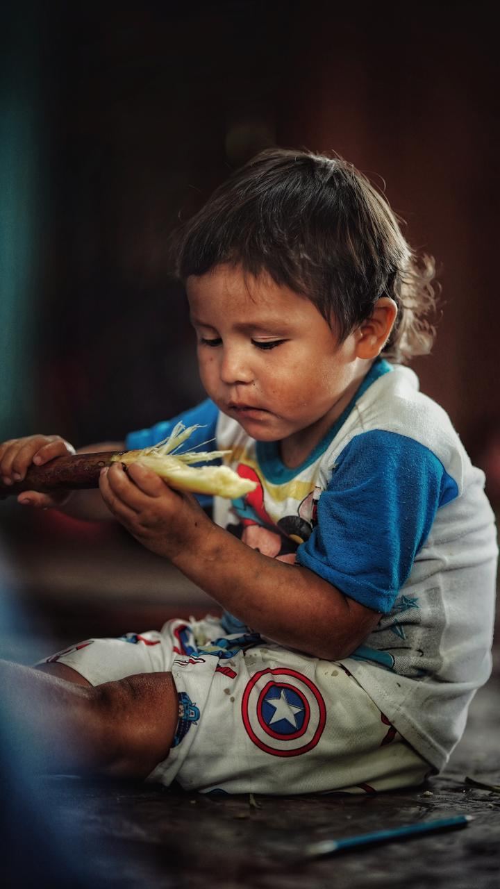 A child holding fruit