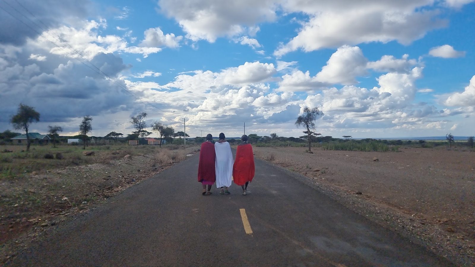 Two Maasai men walking the road at Amboseli