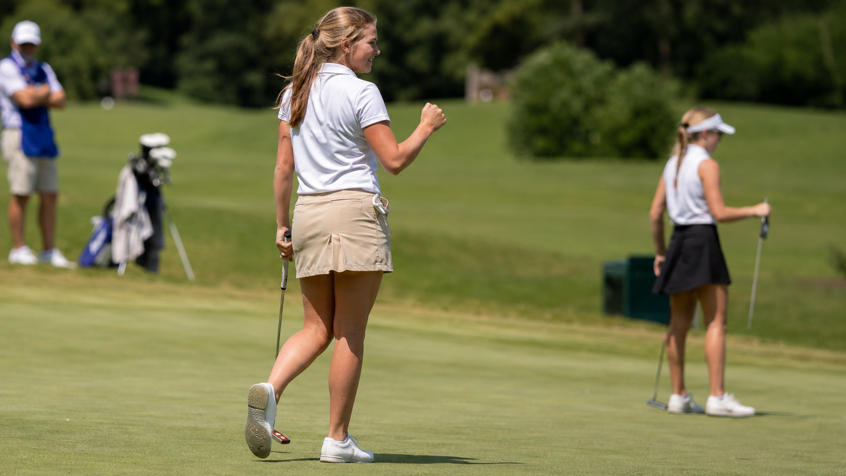 Junior girl golfer celebrating a successful putt during a youth golf tournament while staying focused and confident under pressure on a sunny golf course. Junior girl golfer celebrating a successful putt during a youth golf tournament while staying focused and confident under pressure on a sunny golf course.