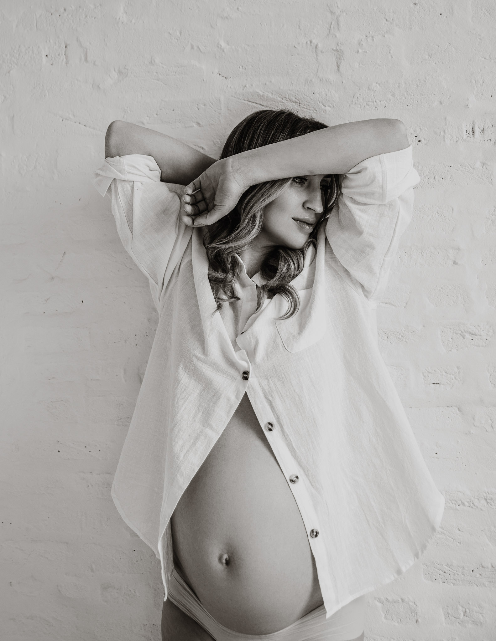 Backlit maternity portrait in white lace
