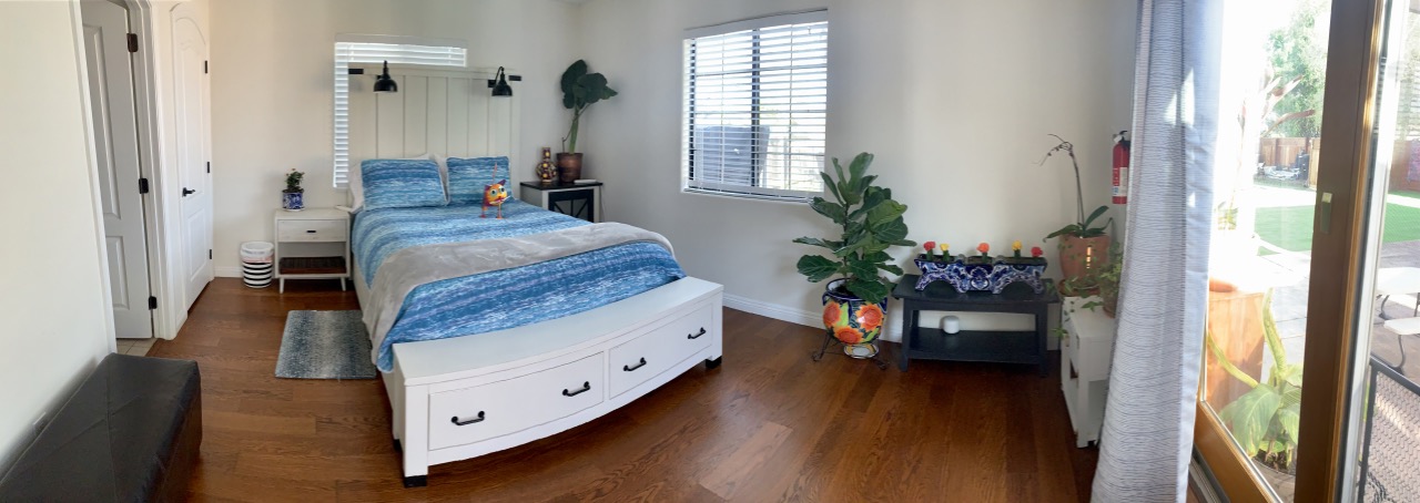 Private bedroom at Casa Sur Hacienda in the San Diego South Bay, featuring a queen bed, natural light, hardwood floors and garden access — ideal for extended stays, retreats and artist residencies in Chula Vista, California.