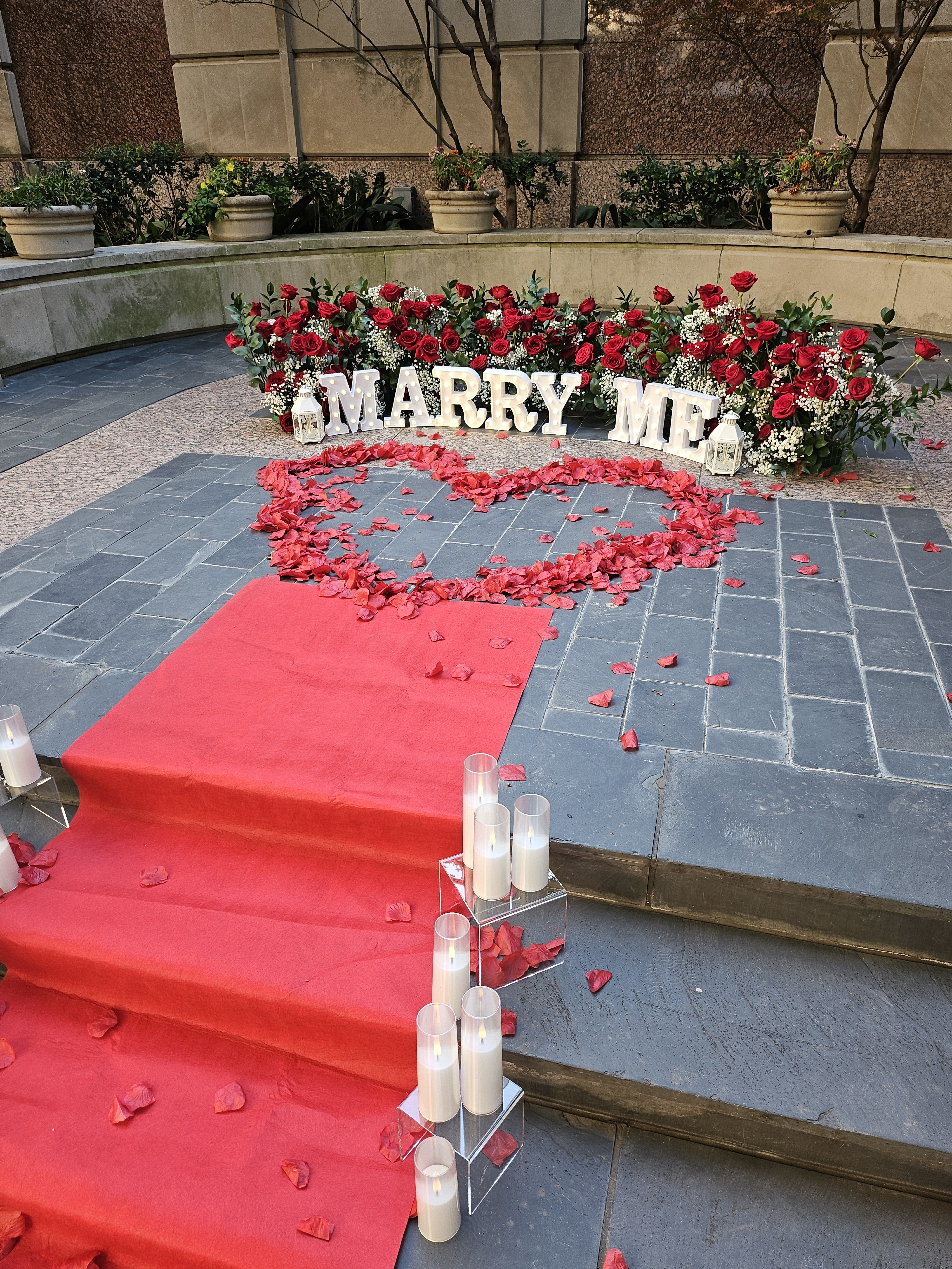 Custom proposal with red carpet and MARRY ME letters