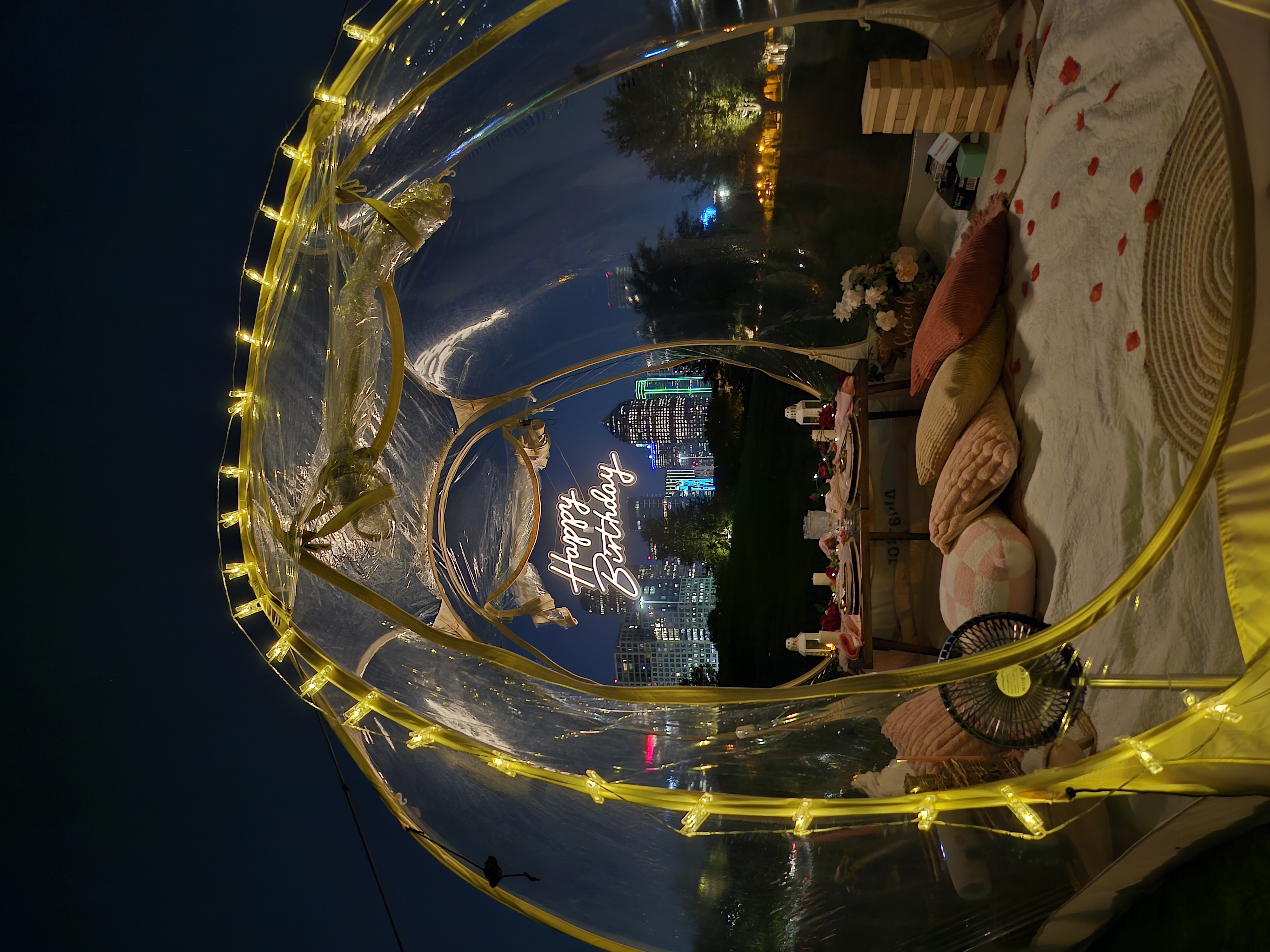 Bubble birthday picnic at night with lit sign