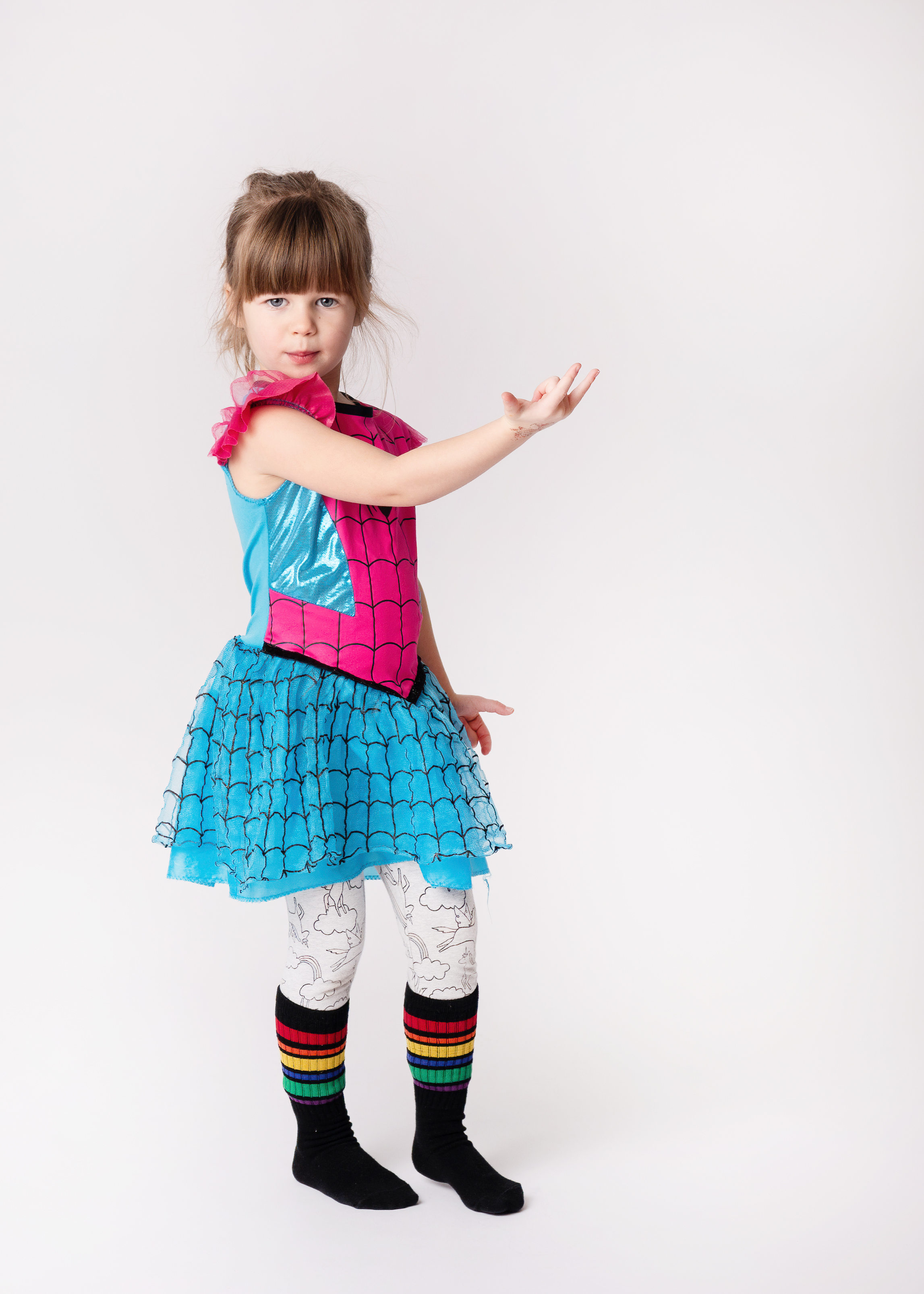 Girl in spider girl costume casting a web