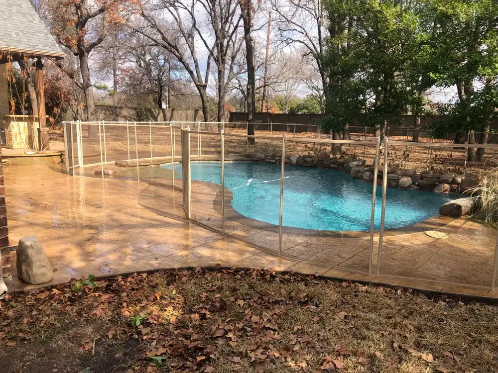 Tan mesh safety fence that blends with stone and deck