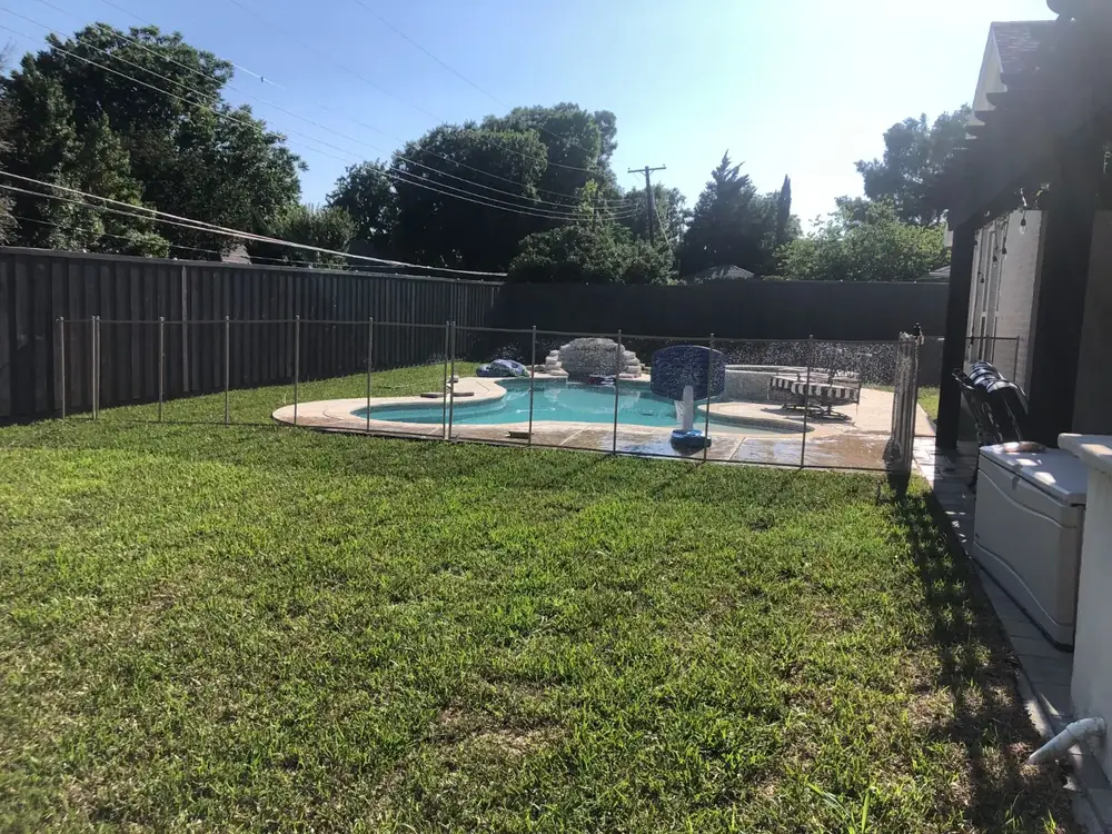 Tan mesh safety fence that blends with stone and deck