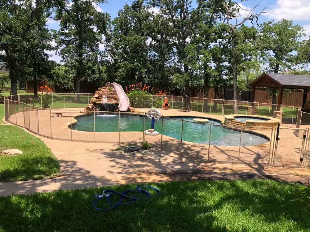 Tan mesh safety fence that blends with stone and deck