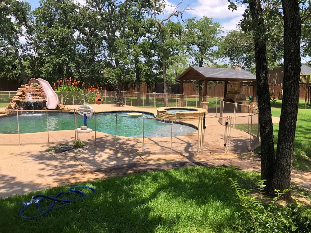 Tan mesh safety fence that blends with stone and deck