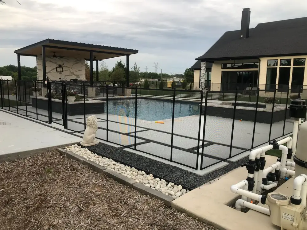 Tan mesh safety fence that blends with stone and deck