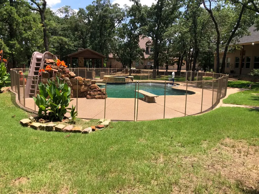 Tan mesh safety fence that blends with stone and deck