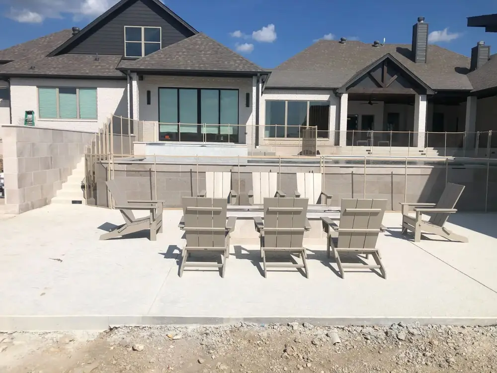 Tan mesh safety fence that blends with stone and deck