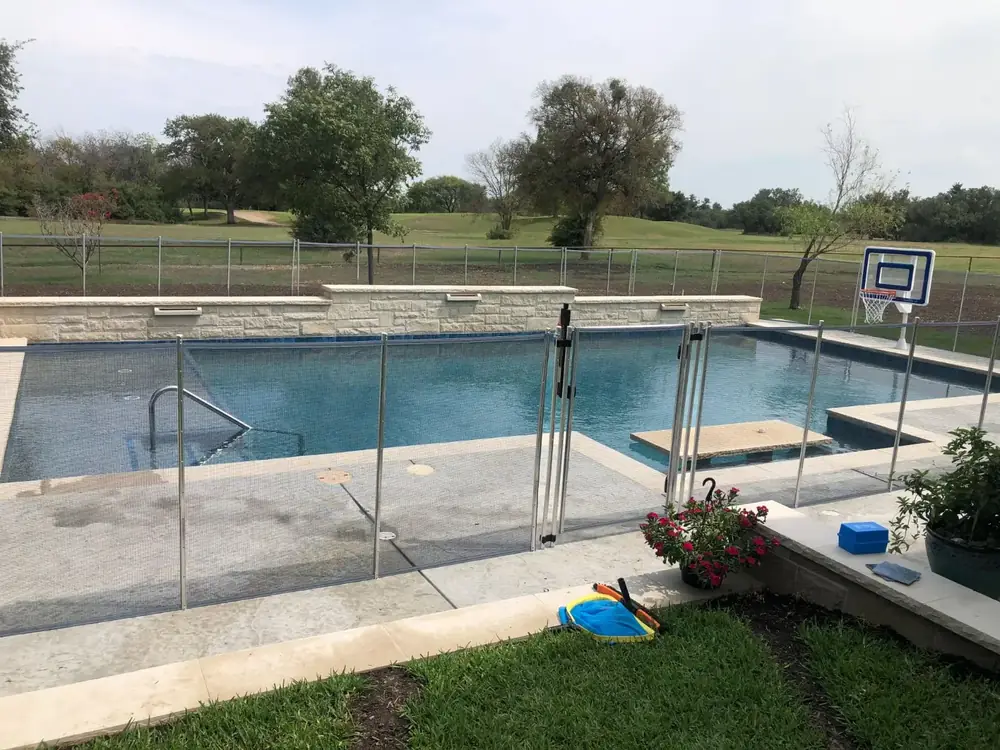 Gray mesh safety fence with silver poles