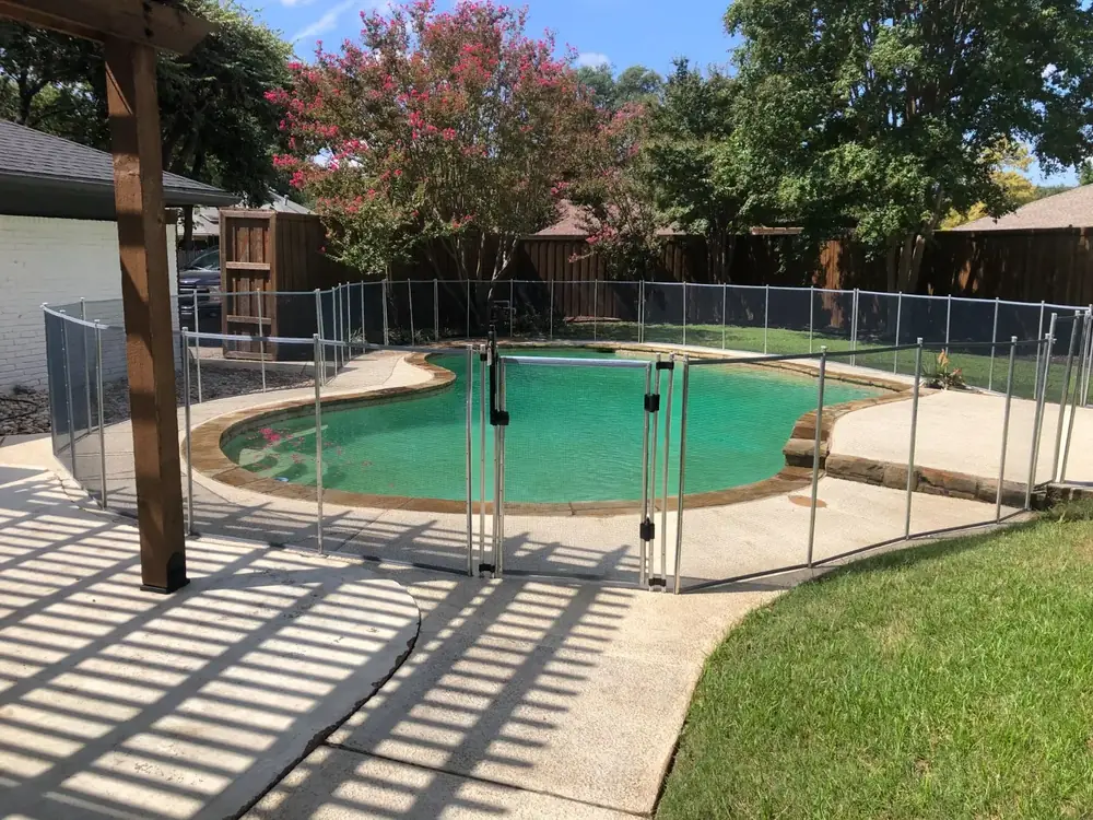 Gray mesh safety fence with silver poles