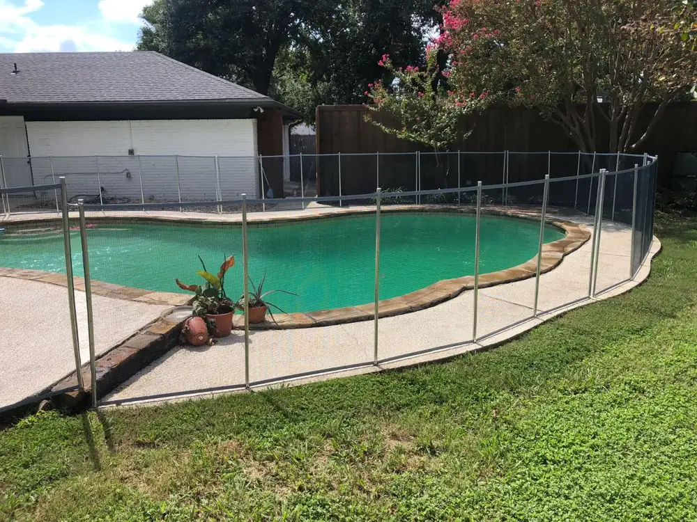 Gray mesh safety fence with silver poles