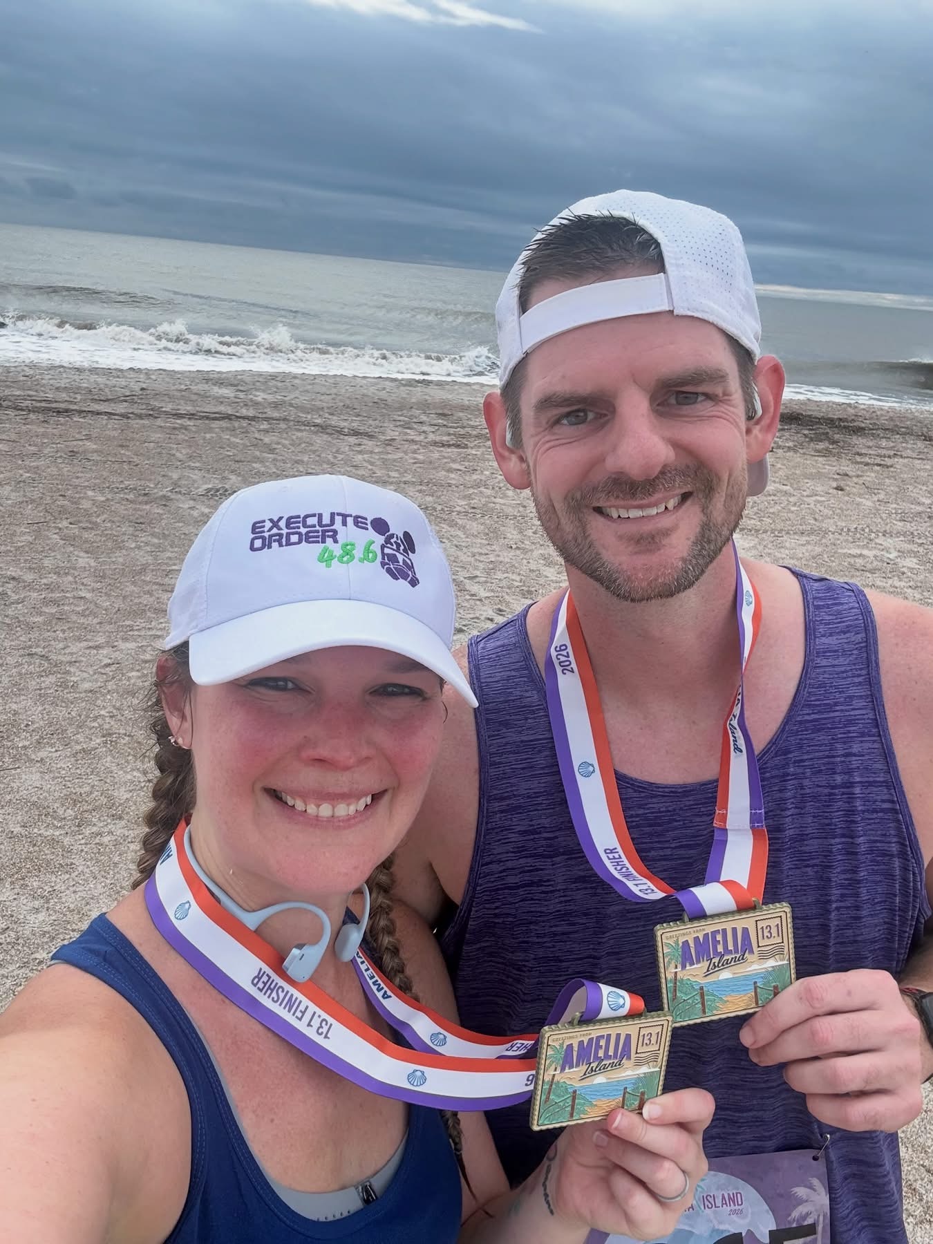 Cameron C. with a race medal at the beach