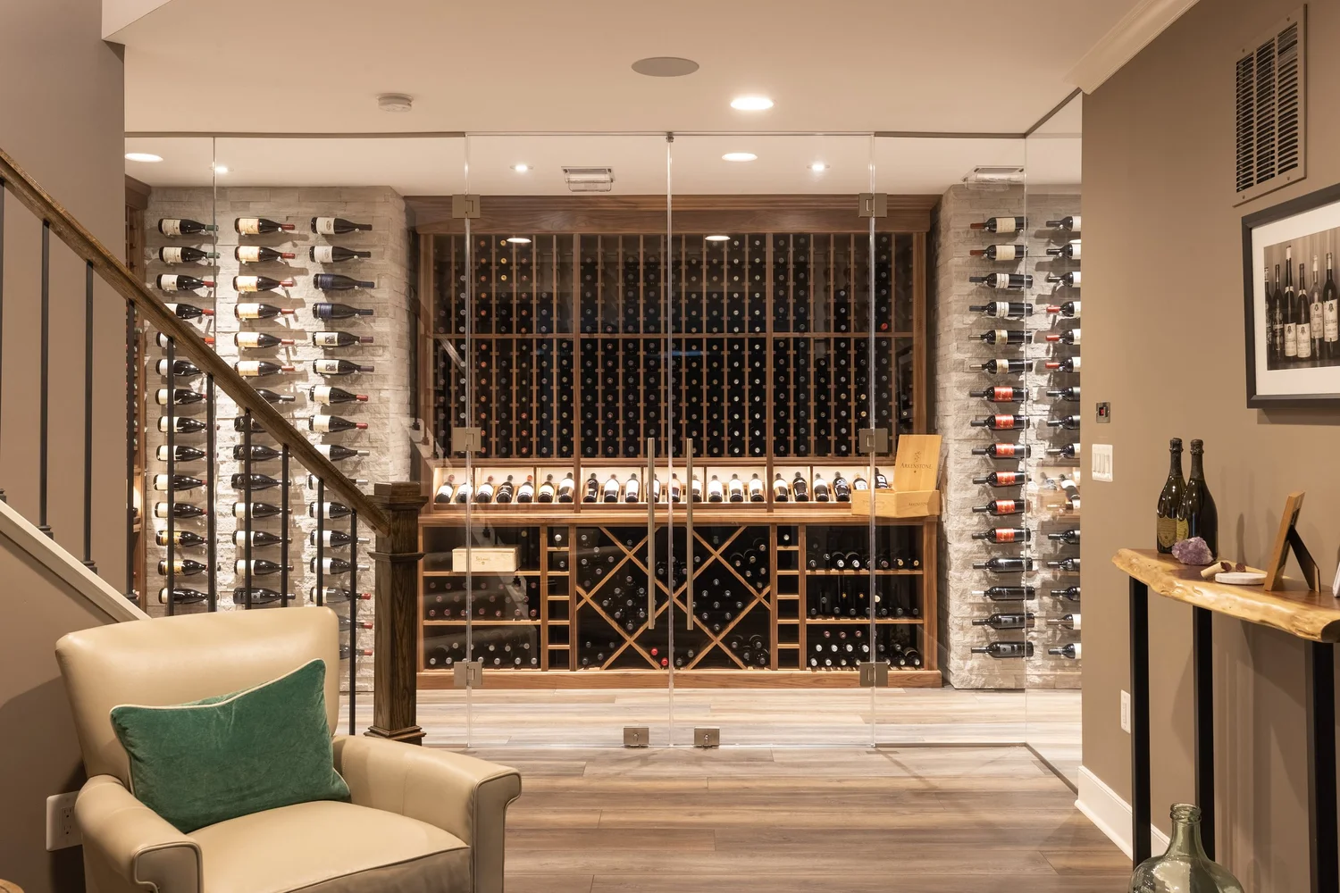 Custom kitchen cabinets designed and built by Wine Cellar Company in a large McLean, Virginia home, featuring floor-to-ceiling cabinetry along a full-length kitchen wall with an integrated butler pantry. The cabinets are finished in a warm neutral tone with traditional millwork details that complement the home's colonial architecture.