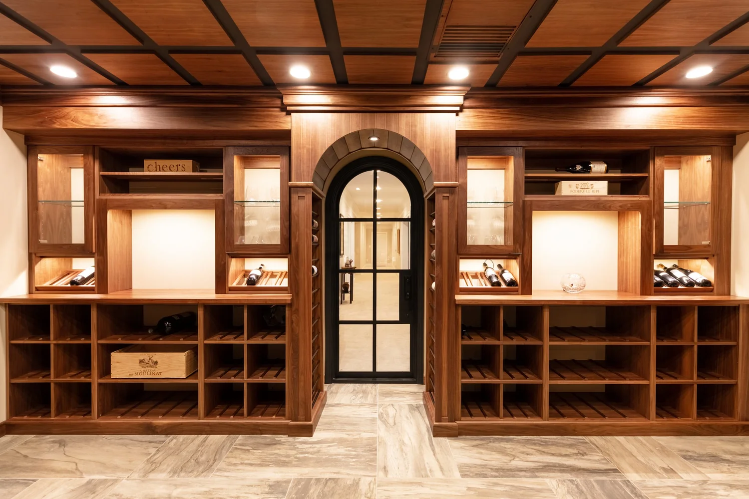 A custom wood-lined sauna room built into a finished basement of a McLean, Virginia home, featuring bench seating, a wall-mounted heater, and warm interior lighting. The wood tones and trim details match the surrounding lower-level finish work.