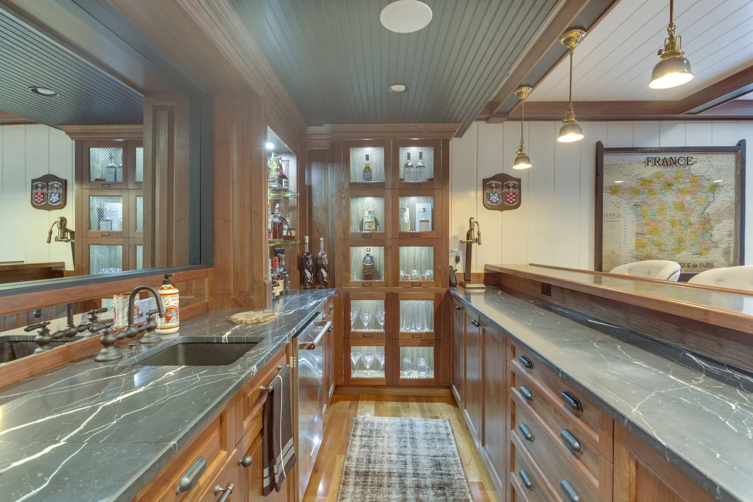 Elegant luxury interior with black, gold, and burgundy accents featuring custom wine cellar display