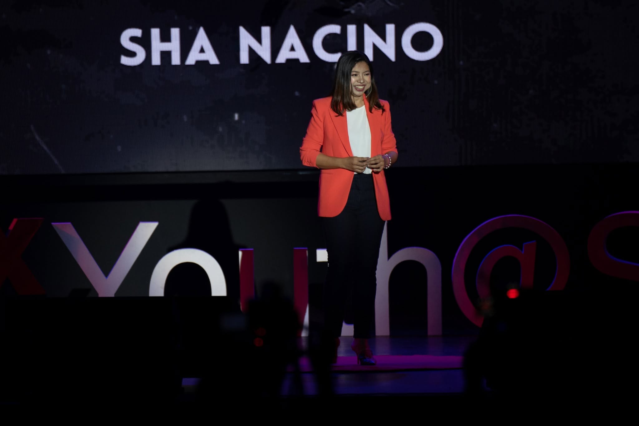Sha Nacino speaking on stage