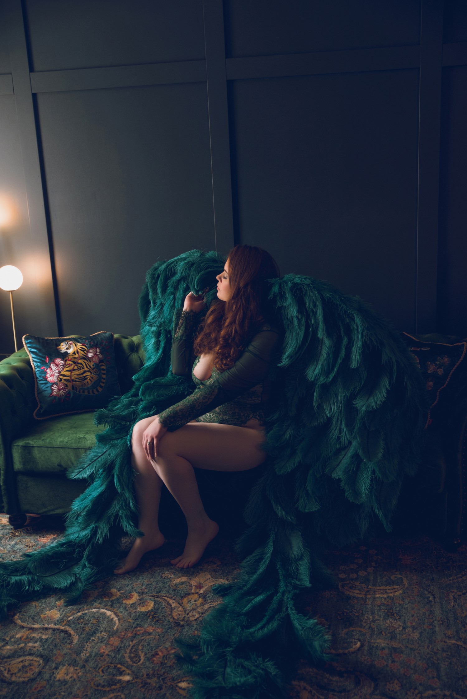 woman sitting on couch while wearing green wings