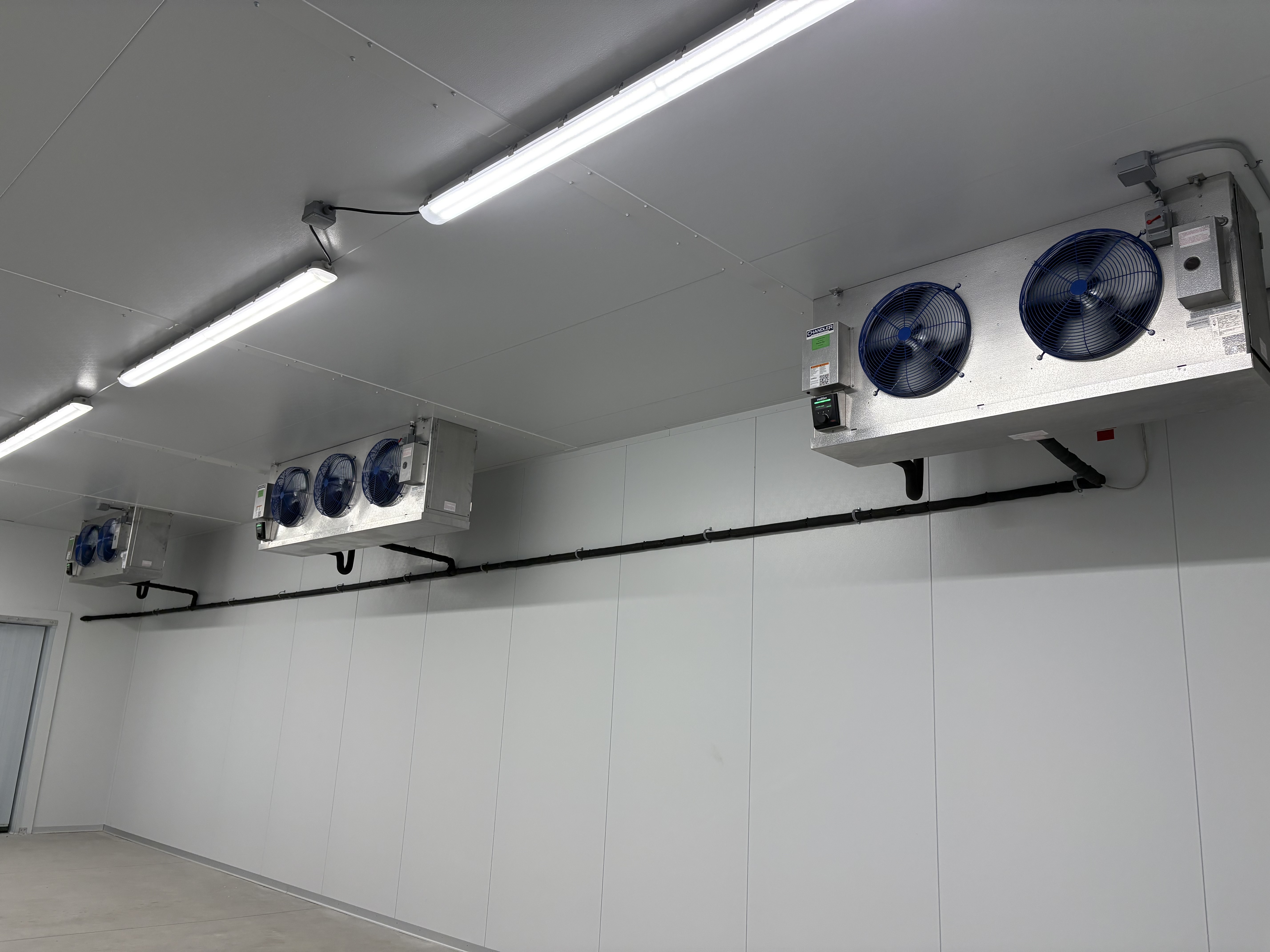 Walk-in cooler evaporator coil inside a commercial unit