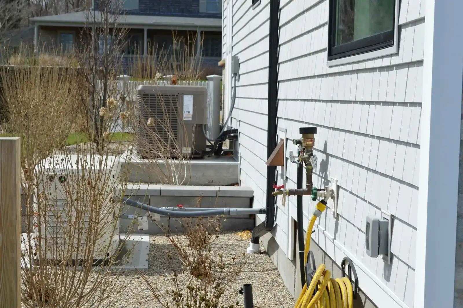 York residential outdoor unit beside a white home