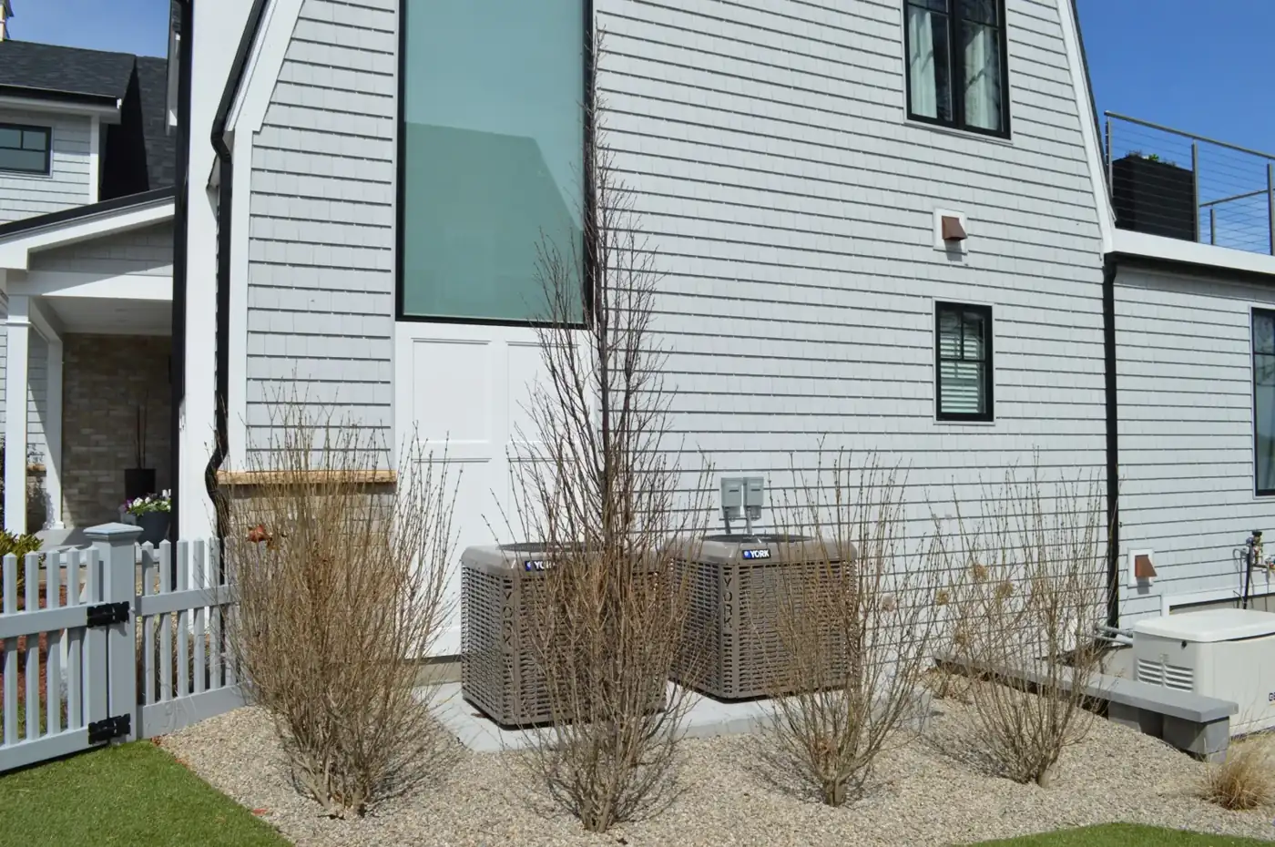 Two condensers installed at the side of a home