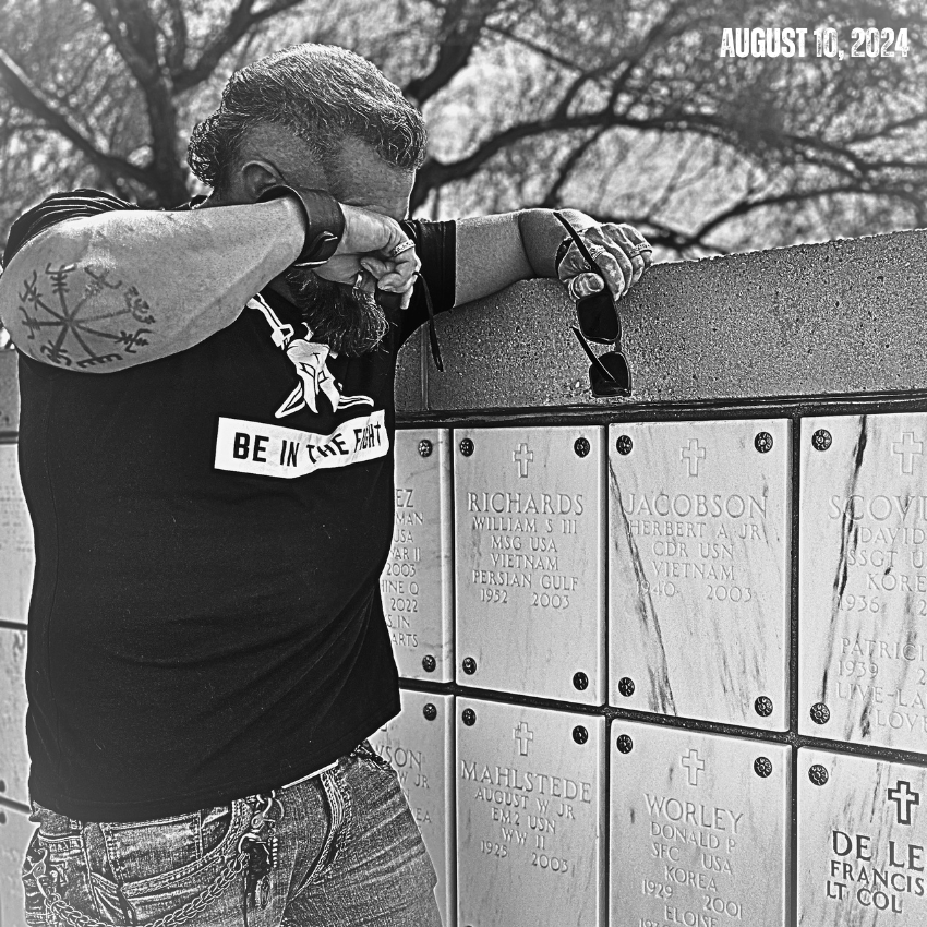 Kirk Jacobson grieving at a memorial wall on August 10, 2024
