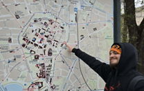 Man pointing at visitors map of Krakow Man pointing at visitors map of Krakow