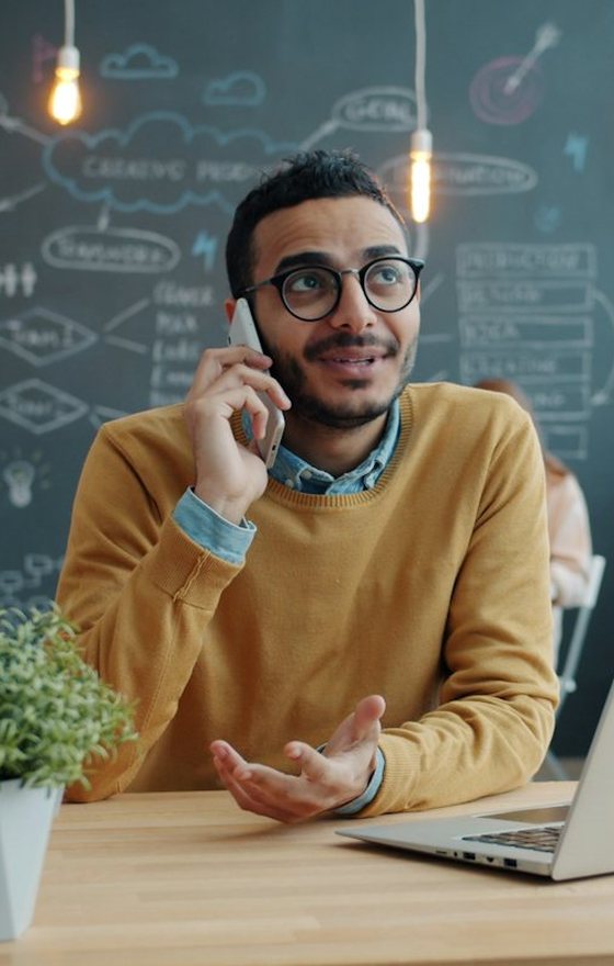 An acquisition manager on a call at his laptop