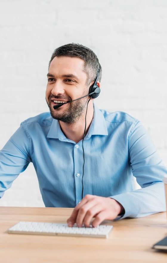 A disposition manager smiling on a headset call