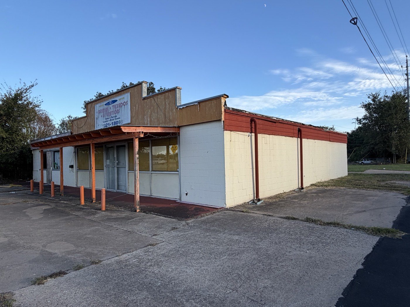 Angled view of the front and side of the building from the parking area