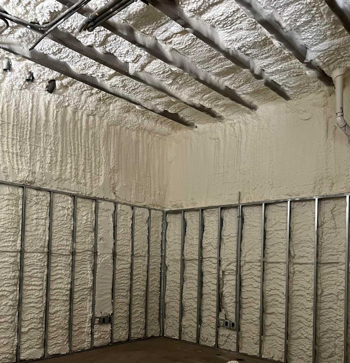 Expert open-cell spray foam insulation on metal framing in Panama City FL by Blue Line Insulation