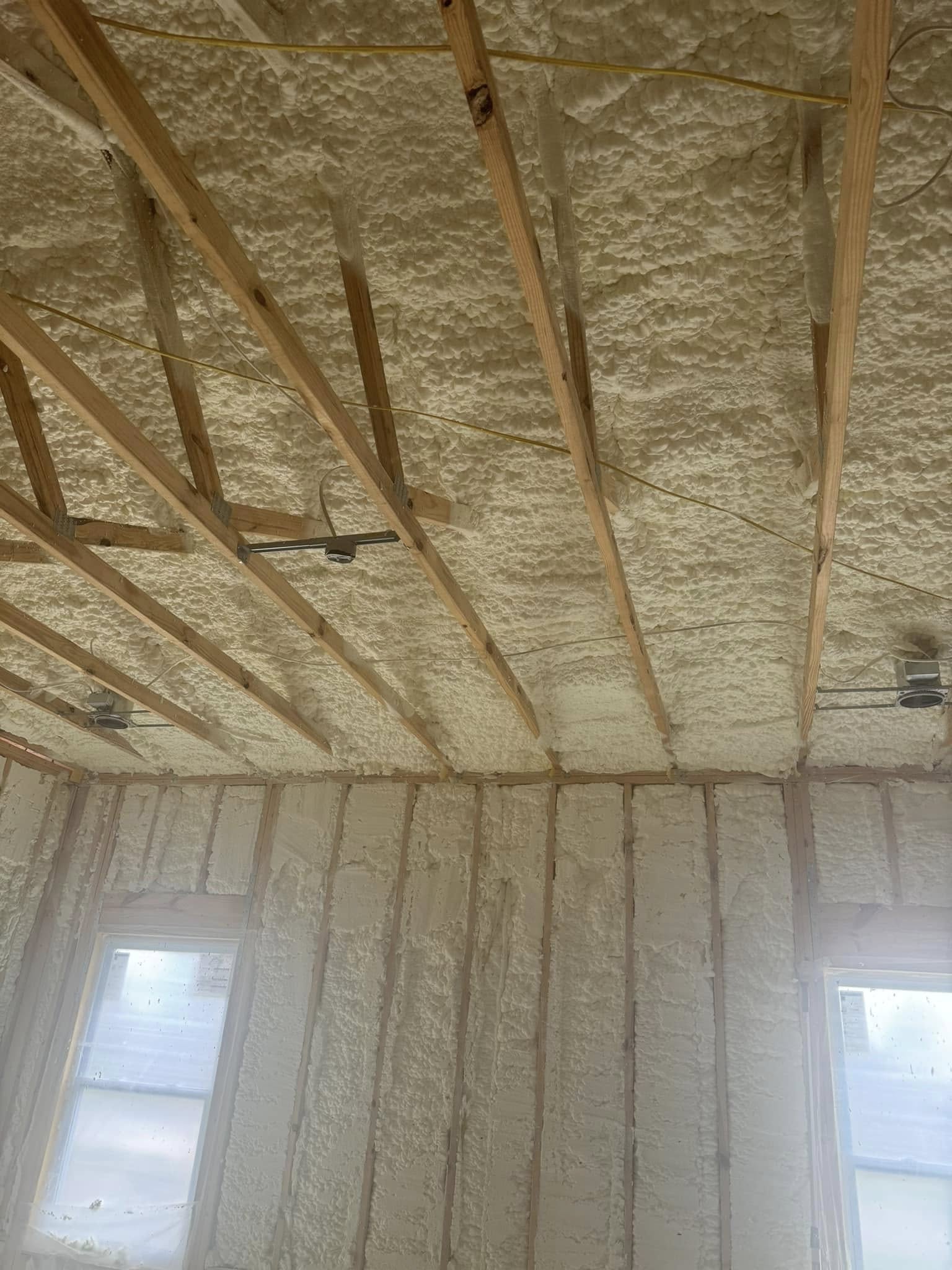 Loose-fill spray foam insulation applied evenly in attic for comfort in Panama City FL by Blue Line Insulation