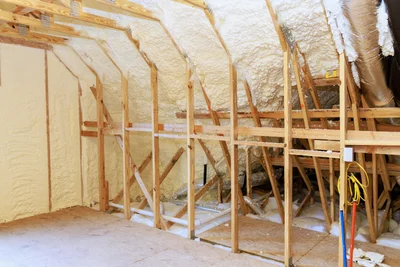 Open-cell spray foam insulation applied to attic walls in Panama City FL by Blue Line Insulation
