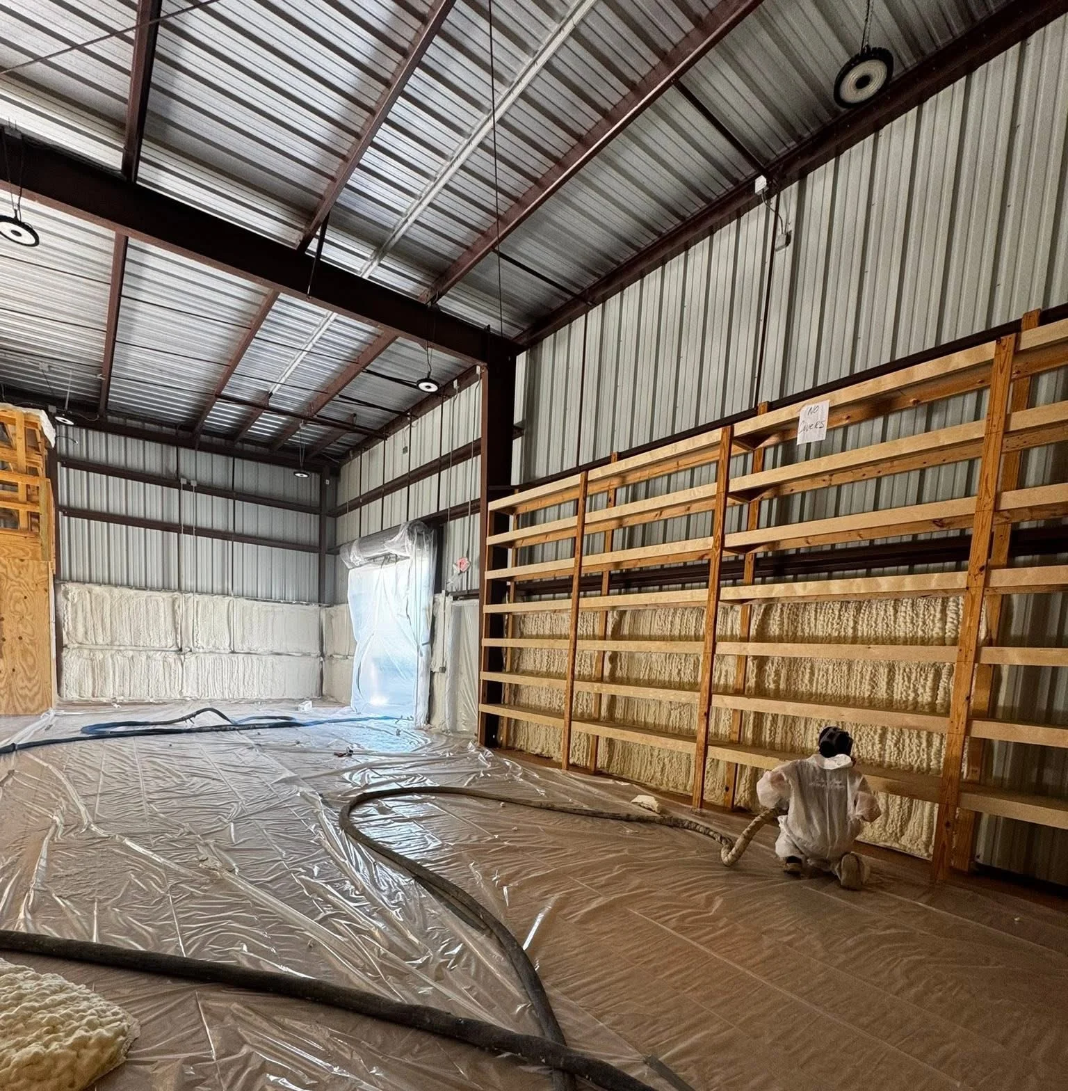 Spray foam insulation applied to interior metal building walls in Panama City FL by Blue Line Insulation