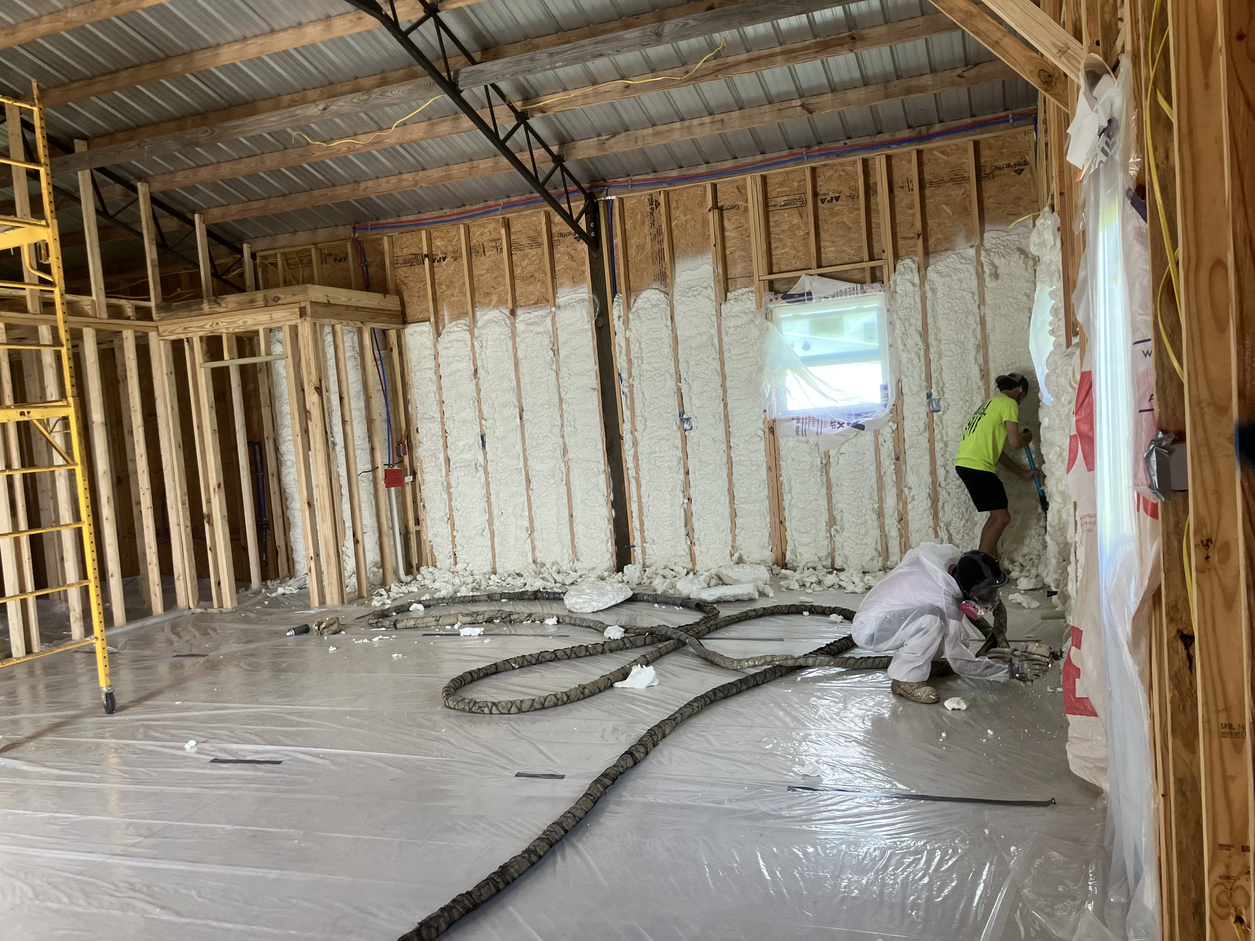 Open-cell spray foam insulation applied to attic walls in Panama City FL by Blue Line Insulation