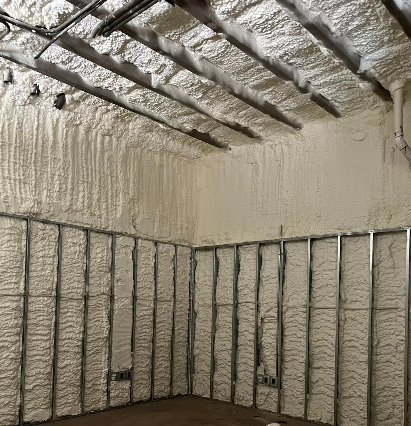 Expert open-cell spray foam insulation on metal framing in Panama City FL by Blue Line Insulation
