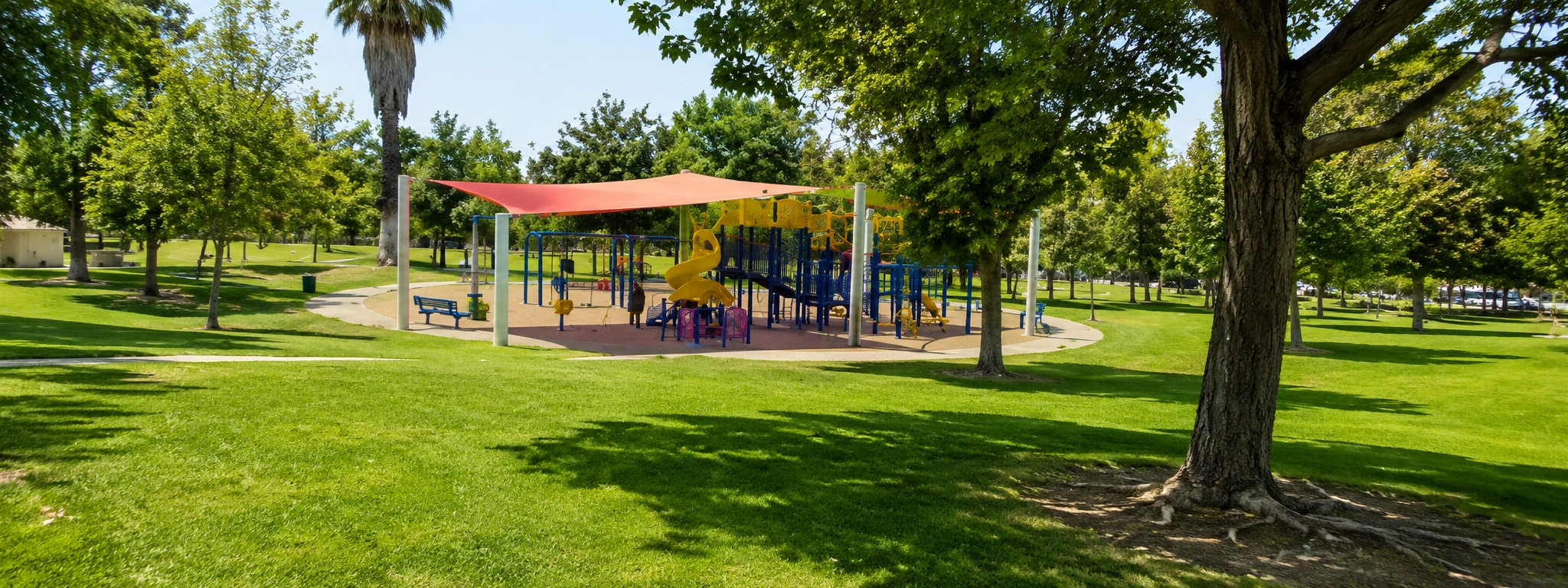 Brookside Park in Redlands California with shaded playground, walking paths, and open green lawns